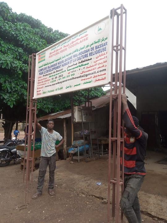 Putting up the school sign, June 2025.